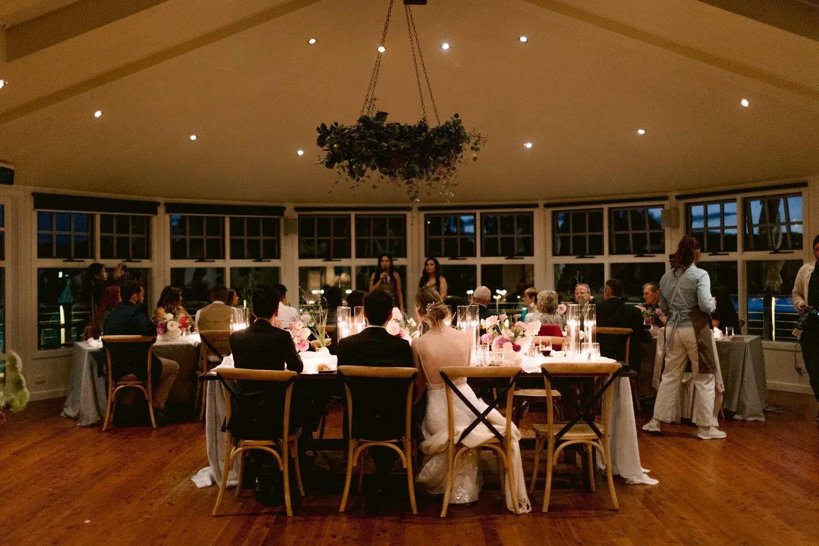 Guests gathered around tables at a wedding reception