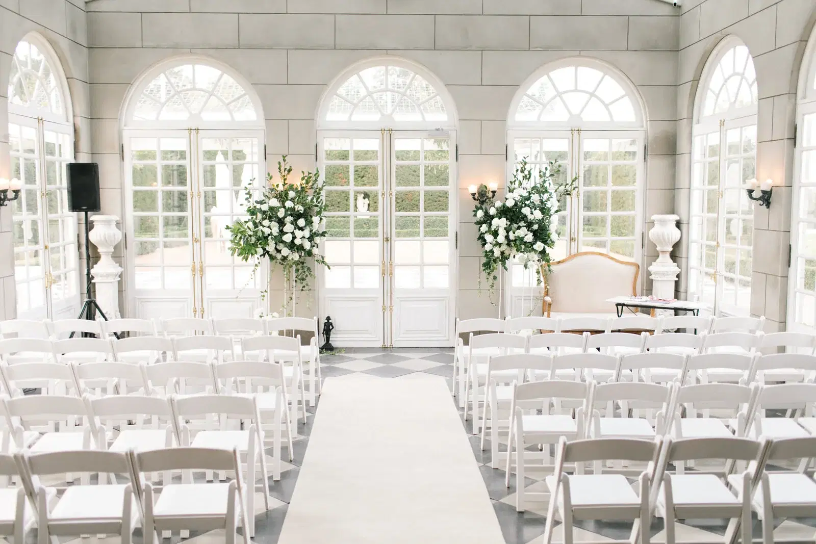 Bright wedding ceremony venue with rows of chairs